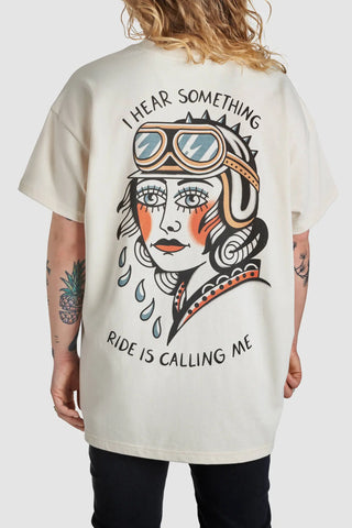 A woman wearing I hear something - ride is calling me motorcycle t-shirt