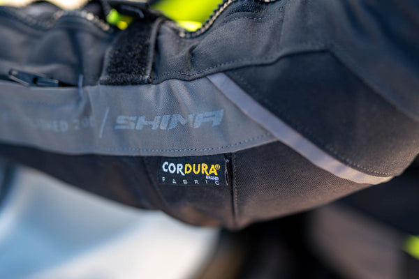 A close up of the Cordura fabric label on the shima motorcycle touring jacket for women in black/ fluo