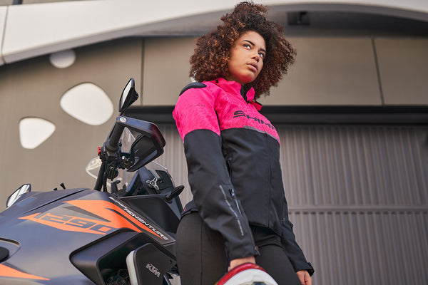 a young woman wearing pink DRIFT  motorcycle jacket from Shima