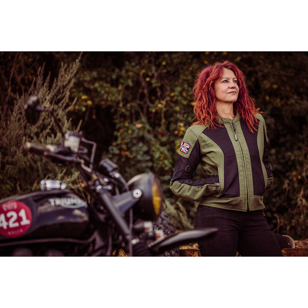 A women standing in front of a motorcycle wearing Women's motorcycle summer mesh jacket in black and green from Moto Girl
