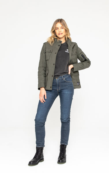 A woman wearing blue mc jeans and a olive green army style lady motorcycle shirt from john doe