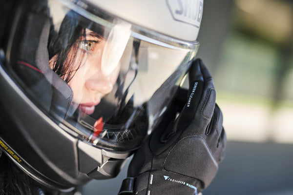 the close up of the woman's face wearing a moorcycle helmet