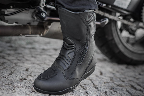 Woman's foot with a black women's motorcycle touring boot from Shima