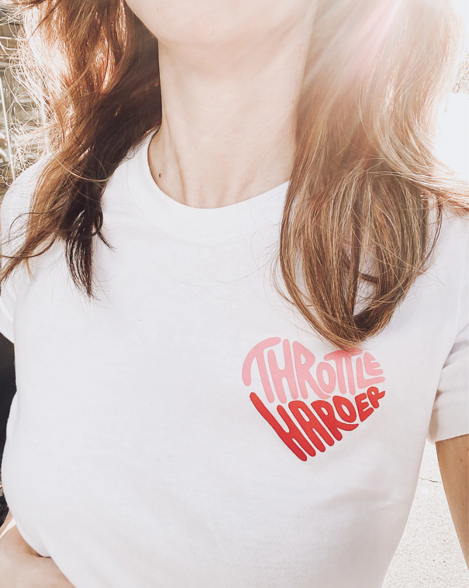 A woman's chest wearing white Throttle harder t-shirt from Black Arrow Label
