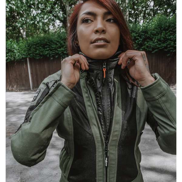 A woman wearing green mesh motorcycle jacket and a wind stop jacket