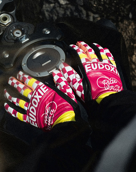 Ride like a Girl pink, black and yellow women's motorcycle gloves from eudoxie on the motorcycle's gas tank