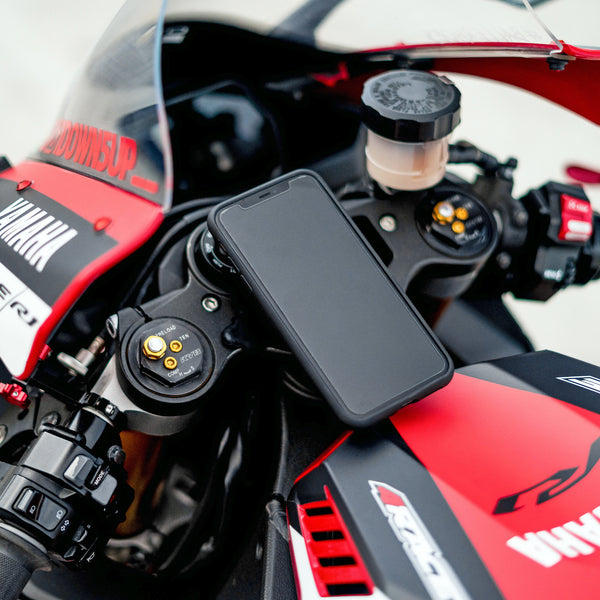 A phone mounted on the red motorcycle 
