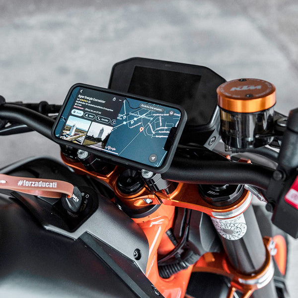 A phone mounted on the motorcycle handlebar