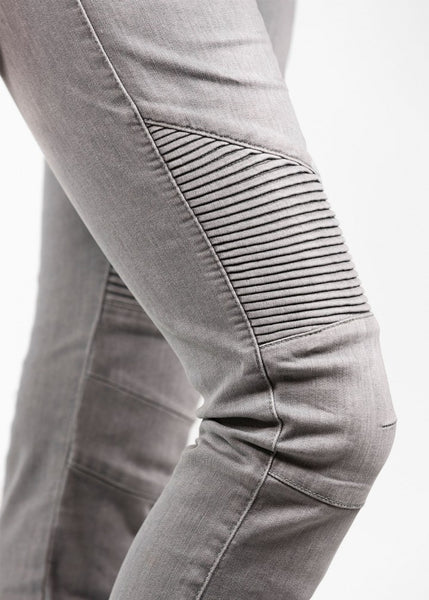 A close up of a woman's knee wearing light grey women's motorcycle jeans from JohnDoe