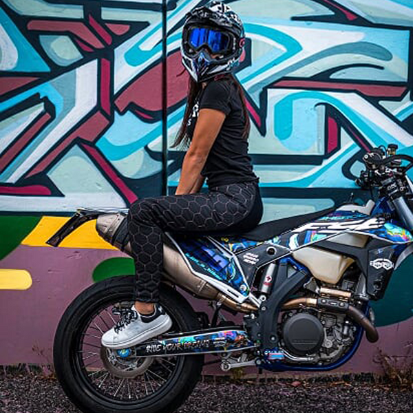A woman wearing black and pink sewed women's motorcycle leggings from exagon66