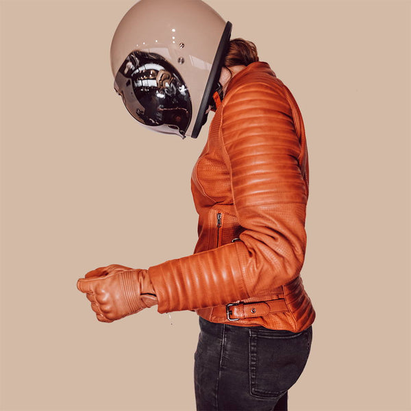 A woman with the helmet wearing Women's red leather motorcycle jacket modern classic style from Black arrow label
