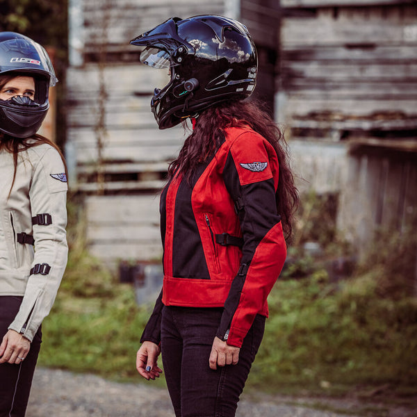 Two women with helmets on  wearing red and white women's motorcycle summer jackets from Moto Girl 