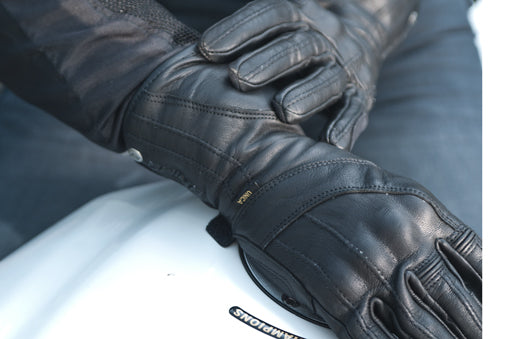 Women hands wearing Long leather black women's motorcycle glove