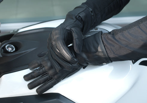 Woman's hands on the motorcycle wearing Long leather black women's motorcycle glove